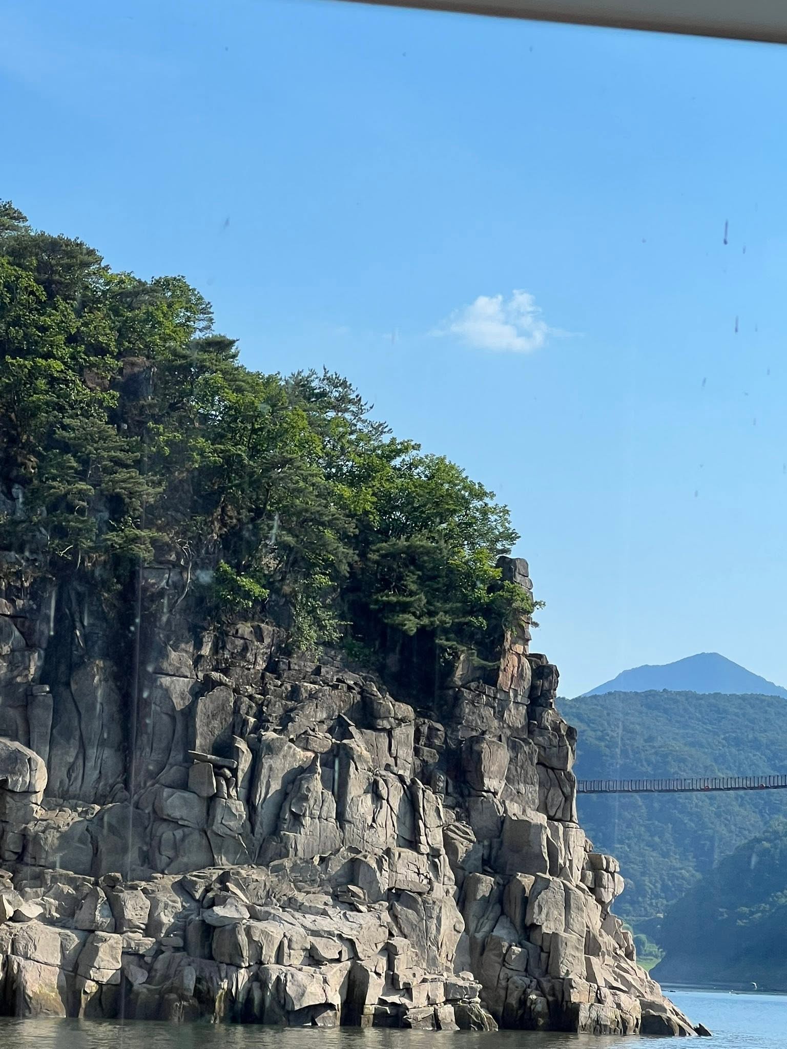 May be an image of train, mountain and lake