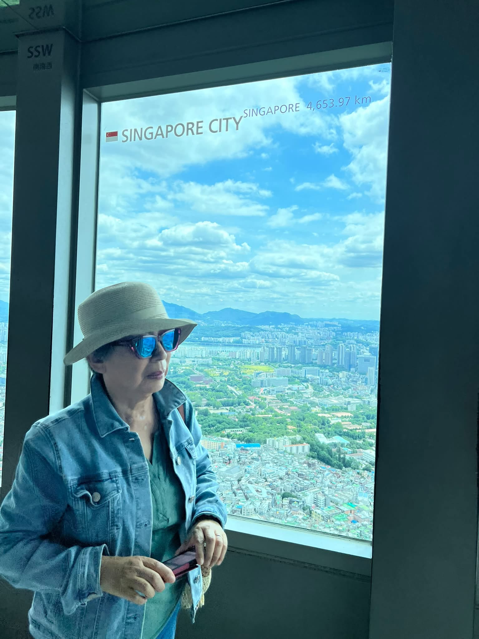 May be an image of hat, cloud, Victoria Peak and text