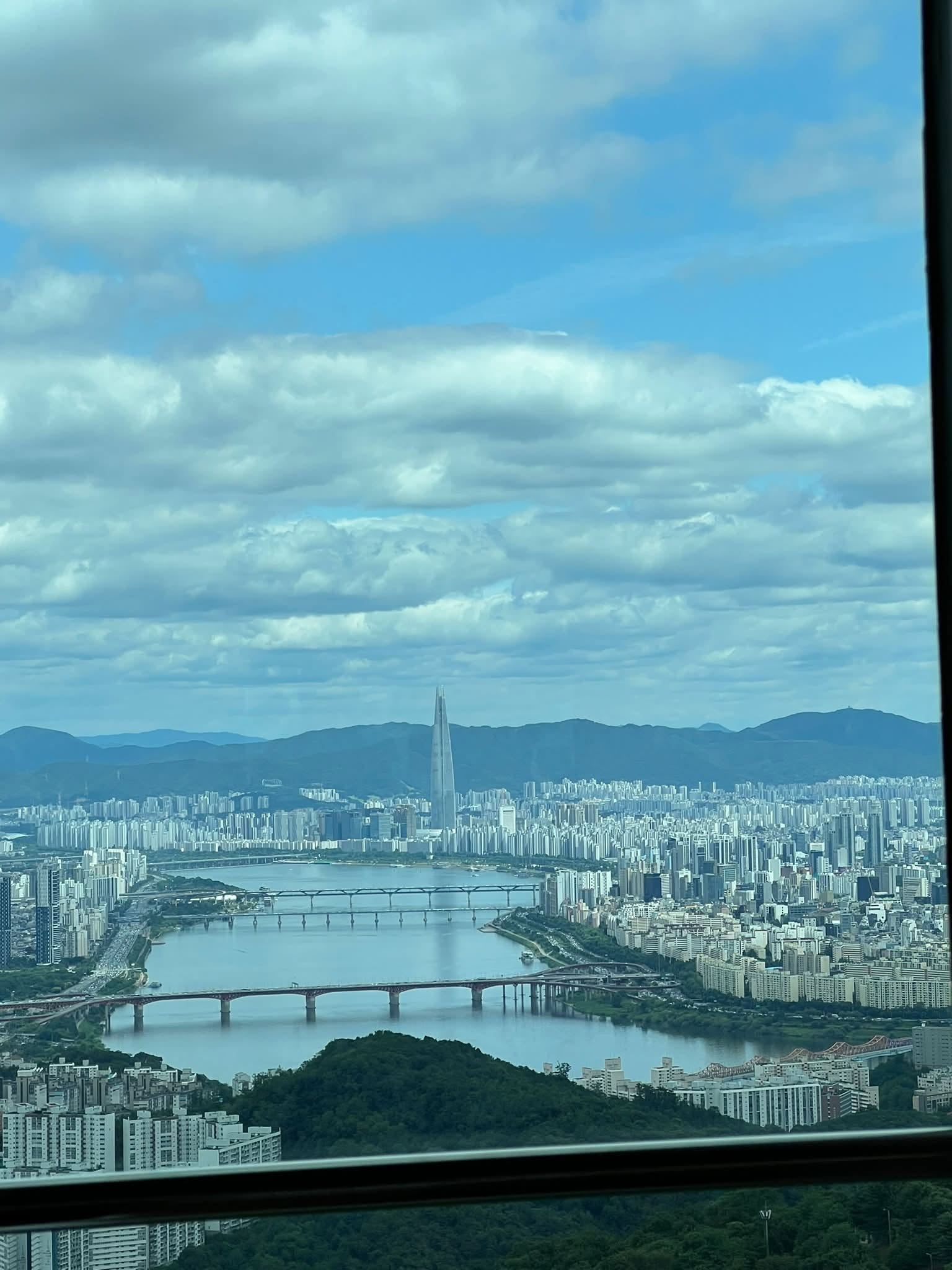 May be an image of cloud, skyscraper and Victoria Peak
